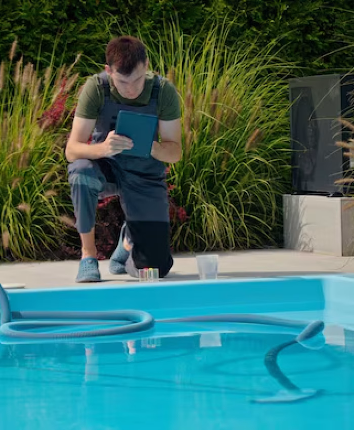 pool-technician-using-tablet-by-pool-surrounded-by-chemical-containers-greenery-focused_1184450-1586 pool-technician-using-tablet-by-pool-surrounded-by-chemical-containers-greenery-focused_1184450-1586